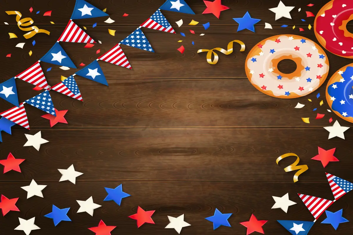 Patriotic-themed decorations with American flag bunting, colorful stars, and doughnuts on a wooden background, celebrating Southern heritage.