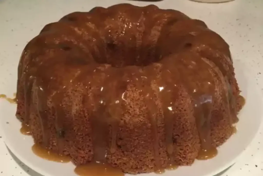 Luscious Salted Caramel Kentucky Butter Cake with glossy caramel glaze on a white plate.