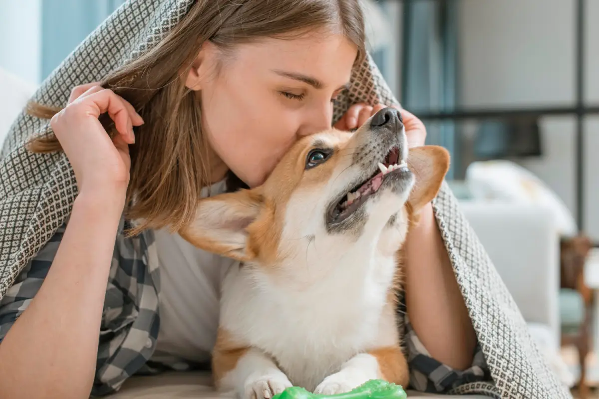 Woman showing affection to her dog, emphasizing the bond and care in choosing safe dog treats instead of Jolly Ranchers