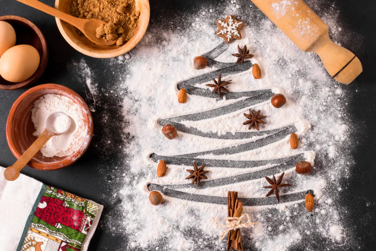 Ingredients for Christmas treat in a Christmas tree shape on a dark surface
