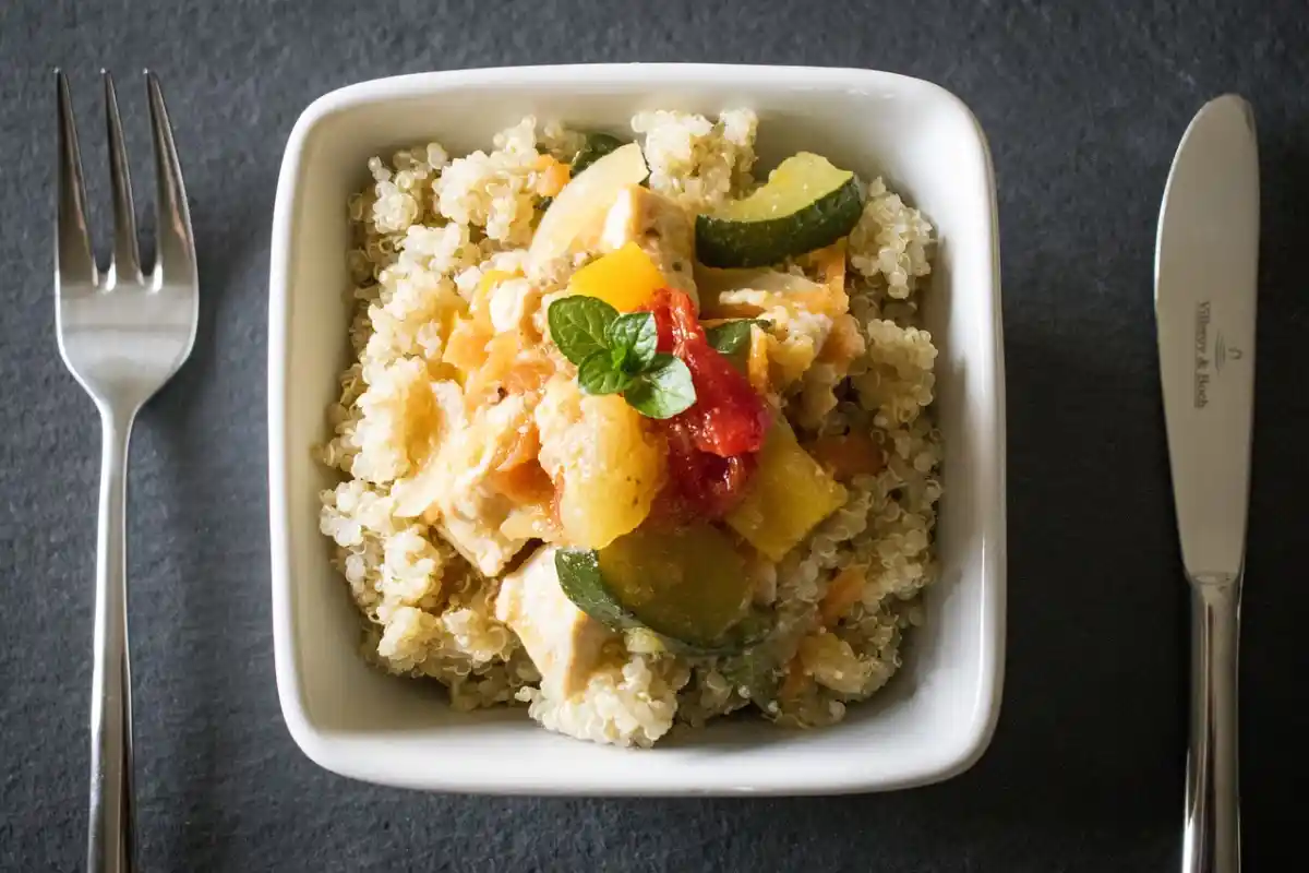 A bowl of quinoa topped with vegetables, presented as a healthy pastina alternative