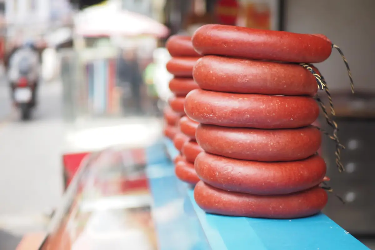 Stack of sausages on display at a market stall