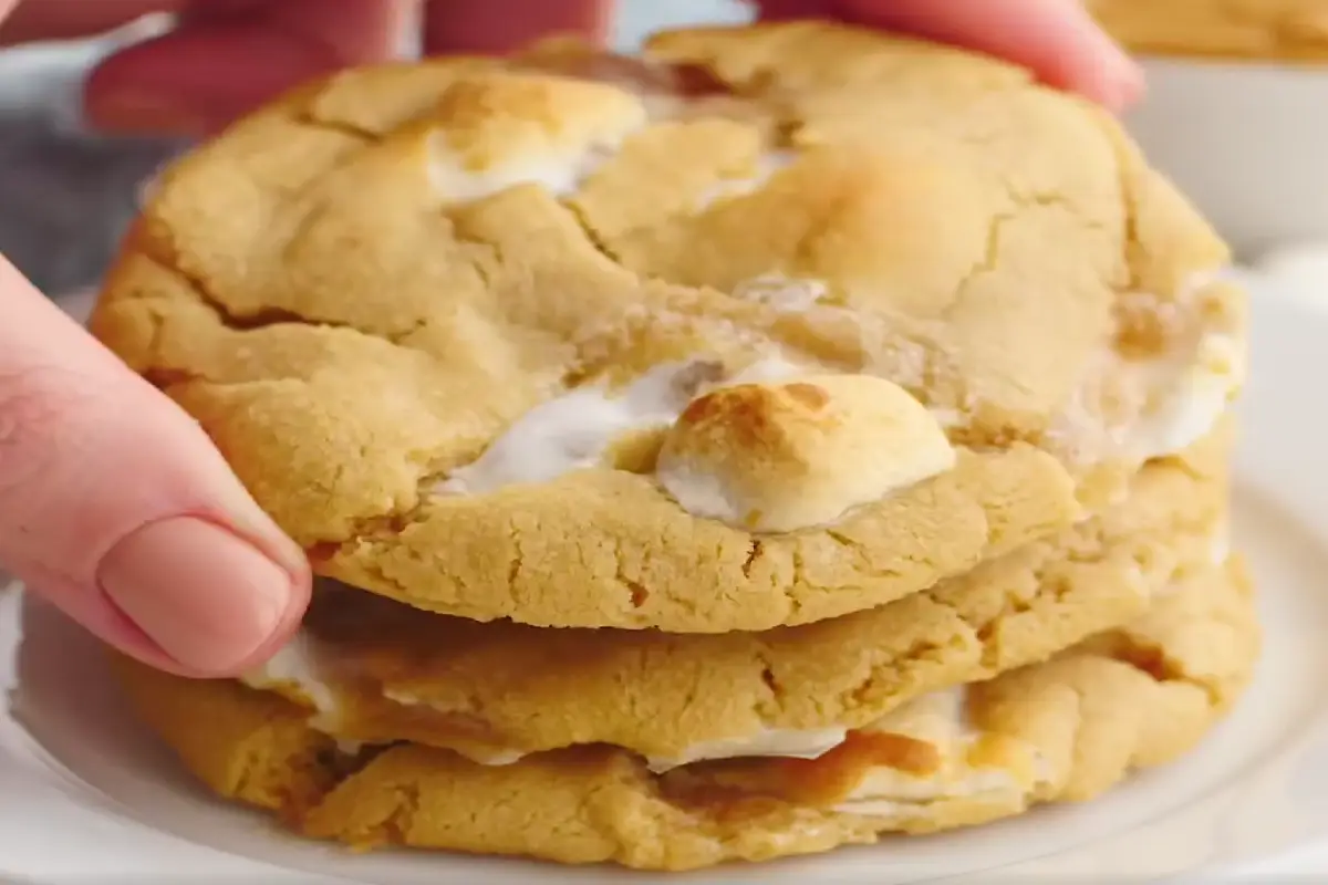 A stack of fluffernutter cookies with gooey marshmallow peeking out.