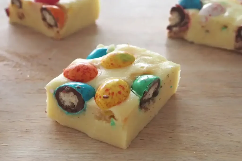 Creamy Easter fudge decorated with vibrant candy eggs.
