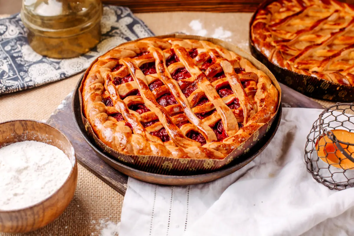 Artisanal strawberry lattice pie on a rustic kitchen setting