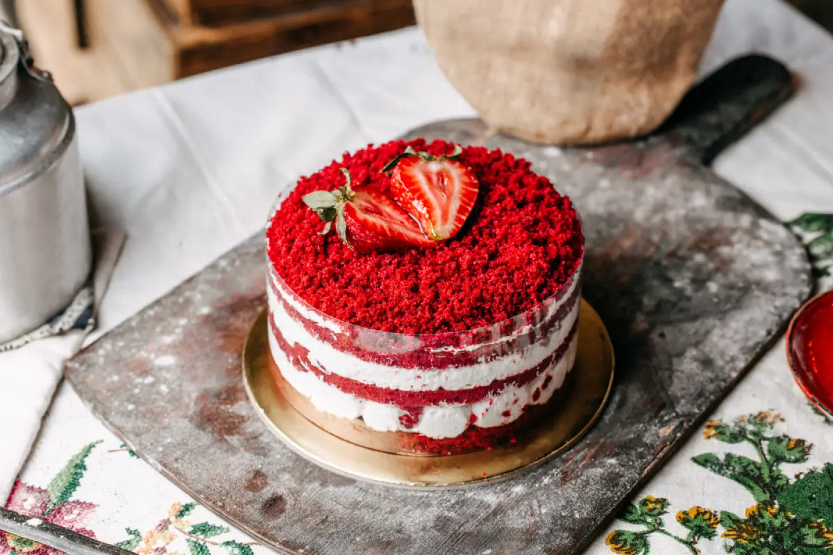 Gourmet red velvet cake with strawberry slices and cream layers