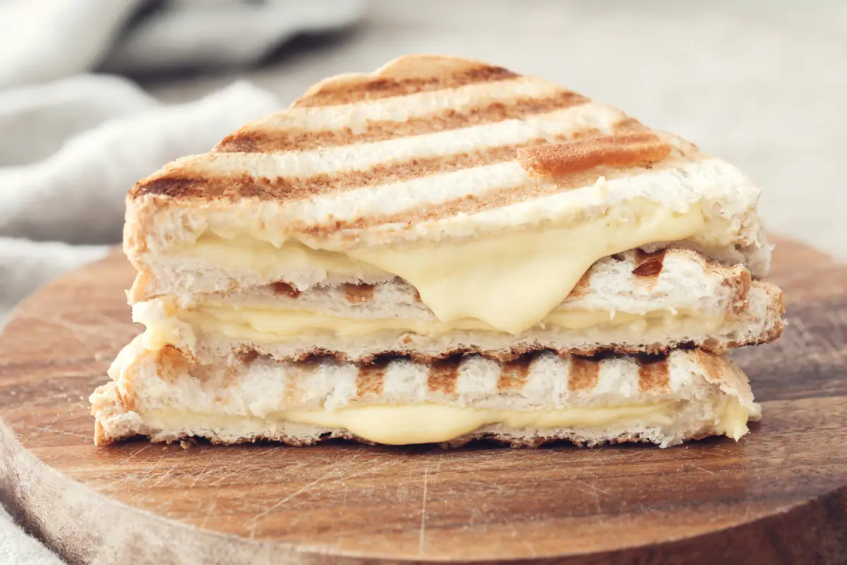 Gourmet Grilled Cheese Sandwich with Brie on a Wooden Board