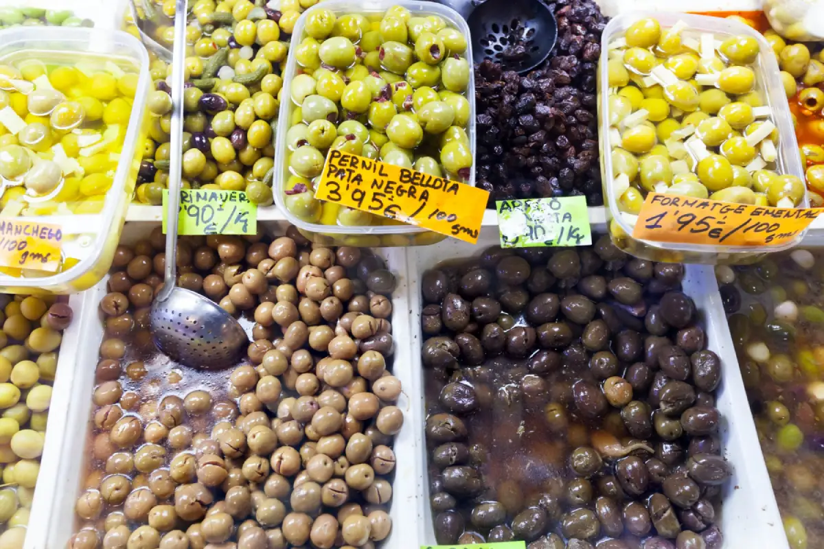 Assortment of olives on display, highlighting Kalamata among other varieties.