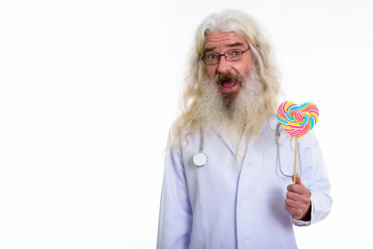 Cheerful senior doctor holding a colorful lollipop, promoting moderation in candy consumption.