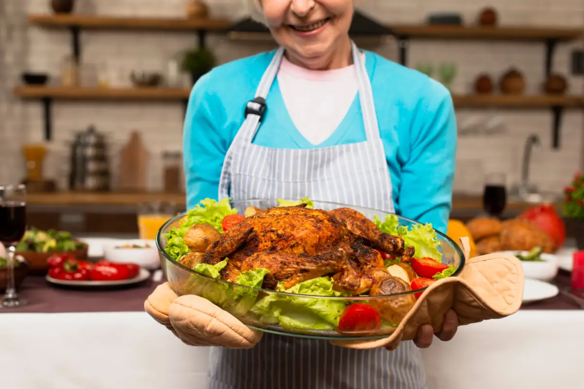 Elderly woman proudly presenting a perfectly basted turkey, ready to serve