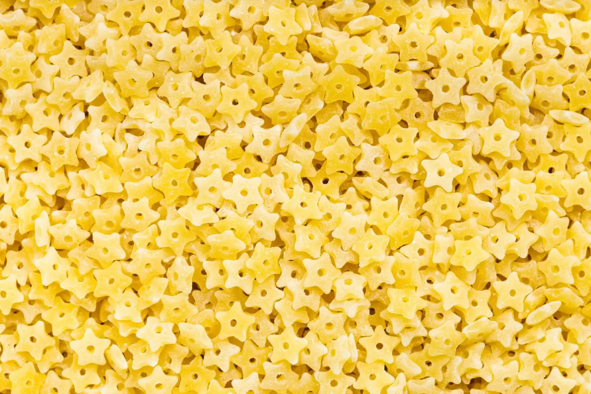 Close-up texture of uncooked stelline pastina, ideal for soup.
