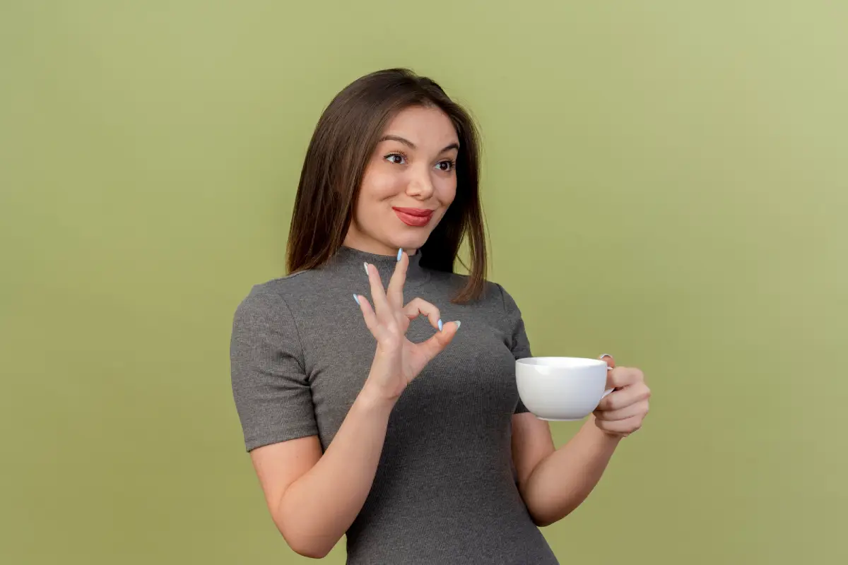 Woman enjoying a cup of tea with a satisfied expression