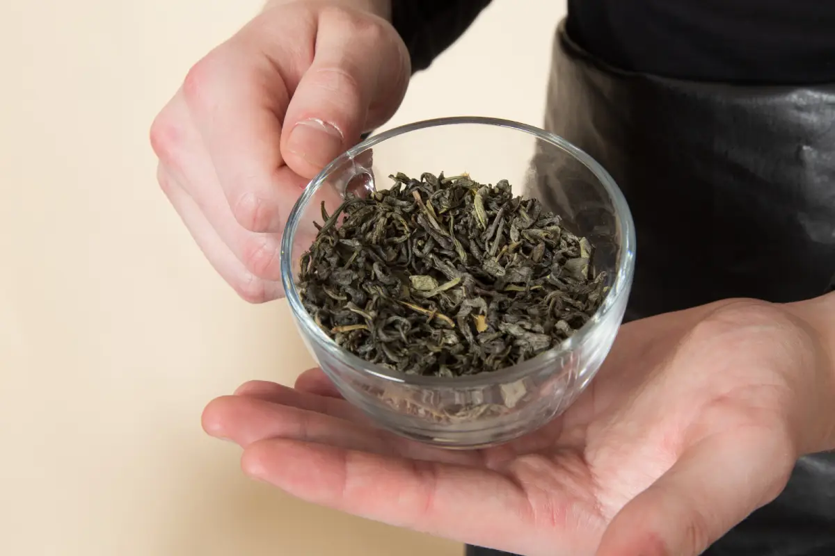 Close-up of loose leaf Earl Grey tea held in hands.