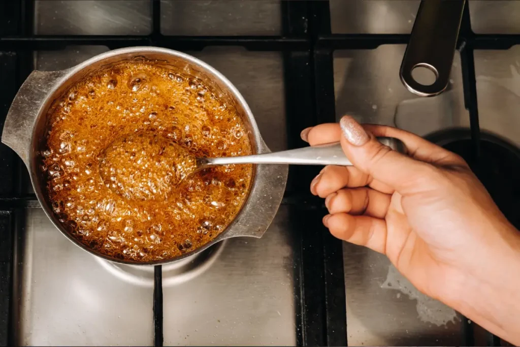 Caramelizing sugar in a pan with a spoon