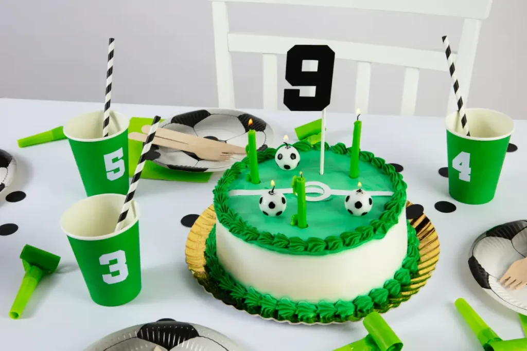 Soccer-themed birthday cake with green frosting and football decorations